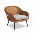 Woven rattan lounge chair with cushion and metal legs for indoor outdoor use
